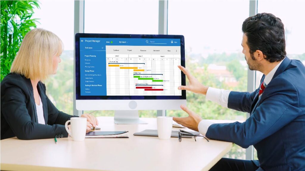 Marketing team reviews a Gantt chart on a desktop screen to fix workflow bottlenecks and common content marketing problems.
